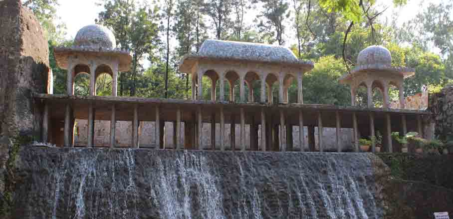 a filigree bridge over a waterfall