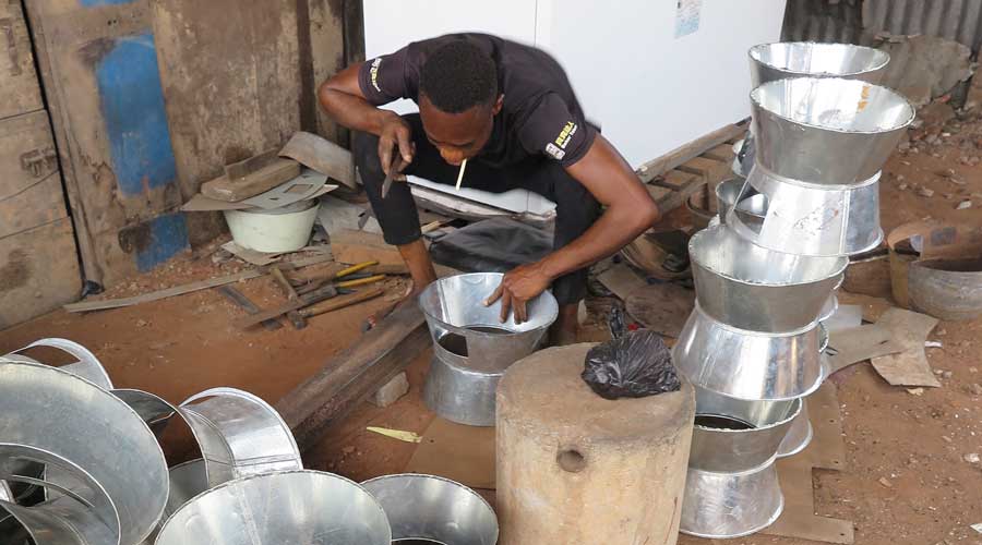 Man working on aluminium pots