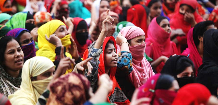 Women protesting in Dhaka and raising their hands