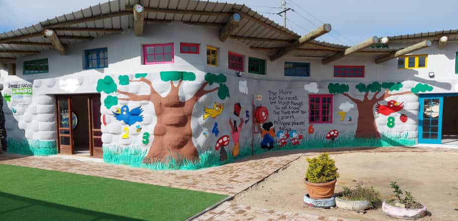 Bright and friendly looking school building with painted pictures on its facade