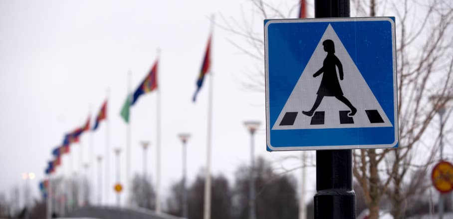 Street sign of a woman crossing a street