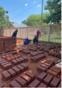 Locals in Galeshewe creating clay bricks for the redevelopment measure.