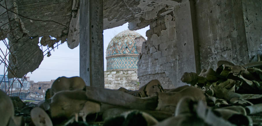 View of an old mosque in Mosul behind rubble