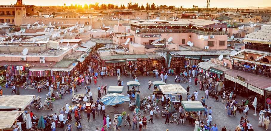 A busy market in Marrakesh at sundown.