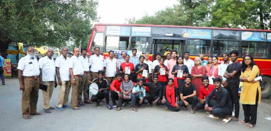 Group photo taken in front of a bus